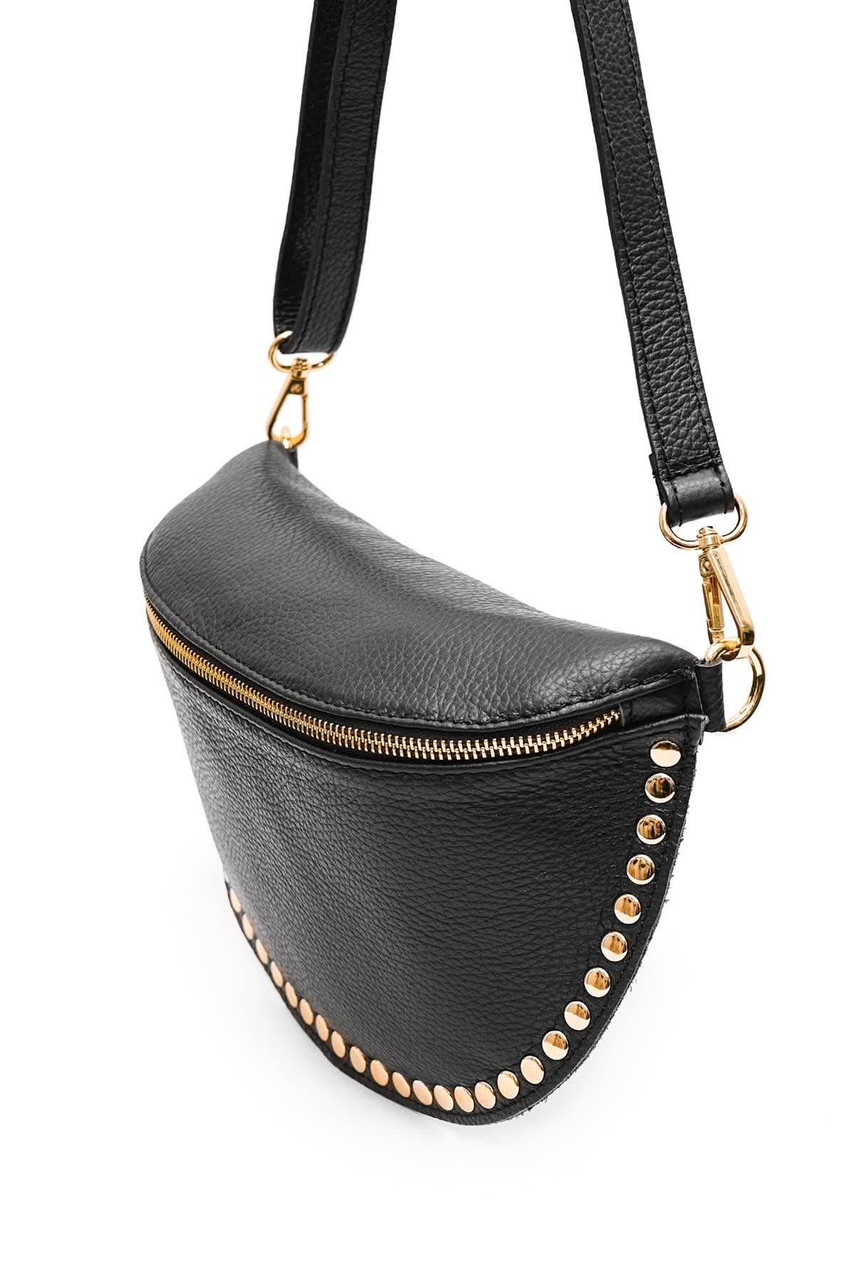 Black fanny pack with gold studs and a strap on a white background