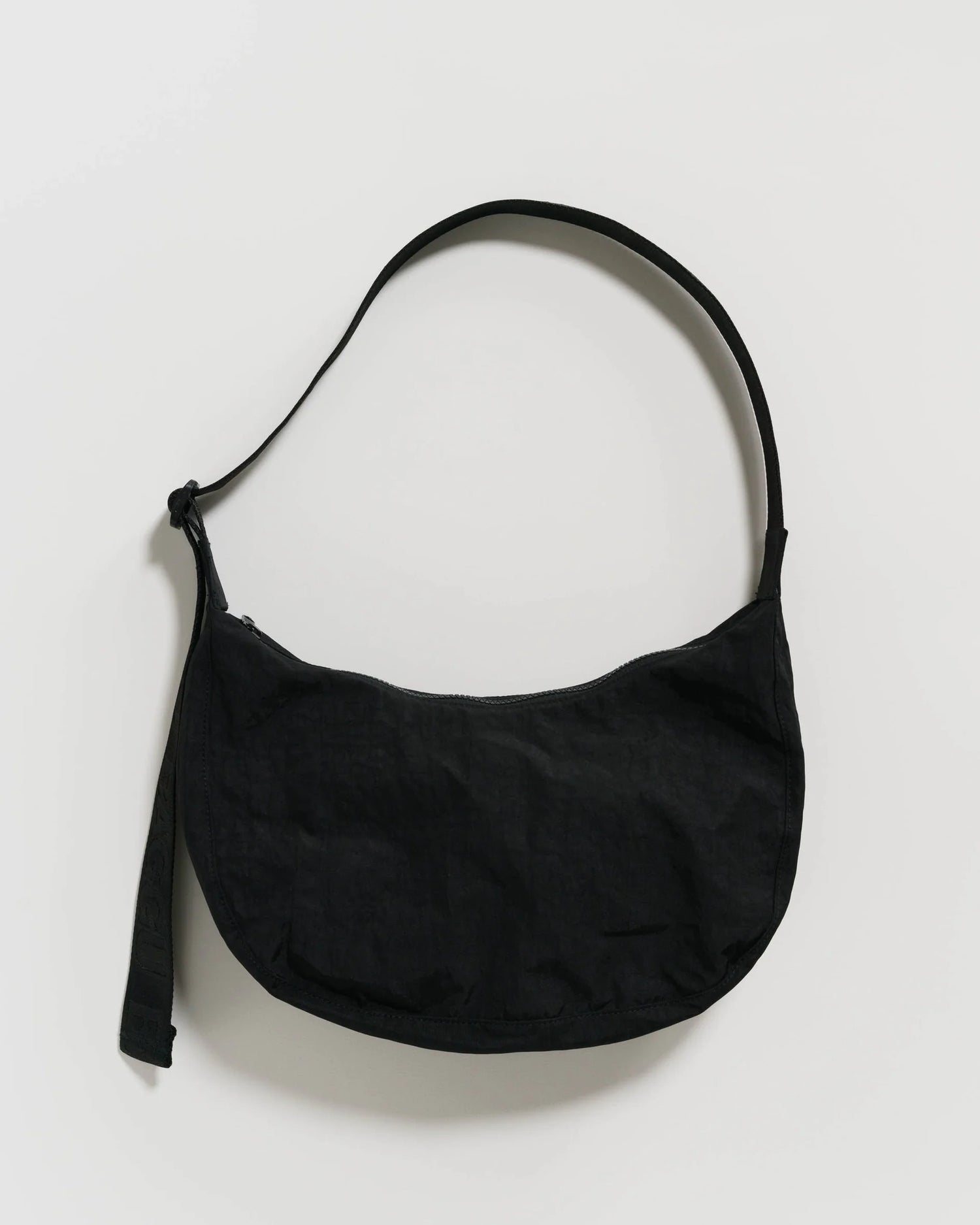 Black shoulder bag on a light gray background