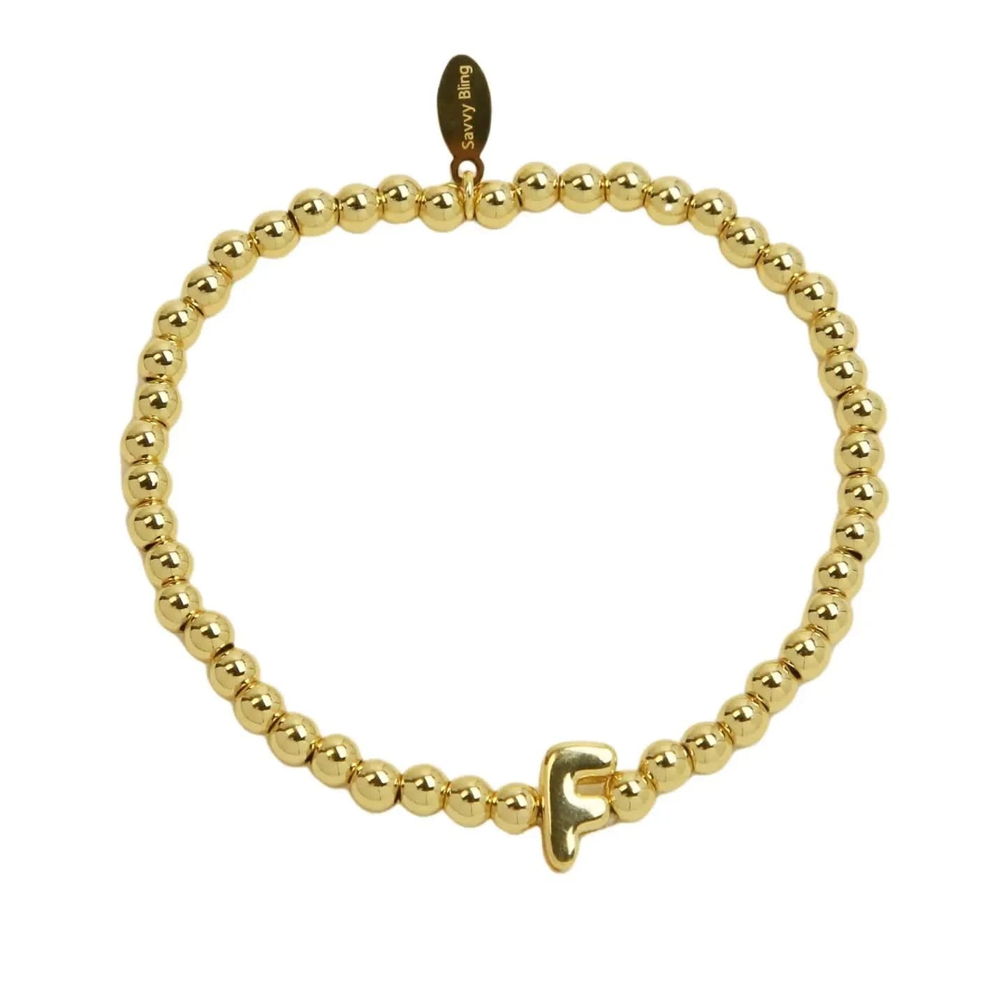 Gold beaded bracelet with a clasp on a white background