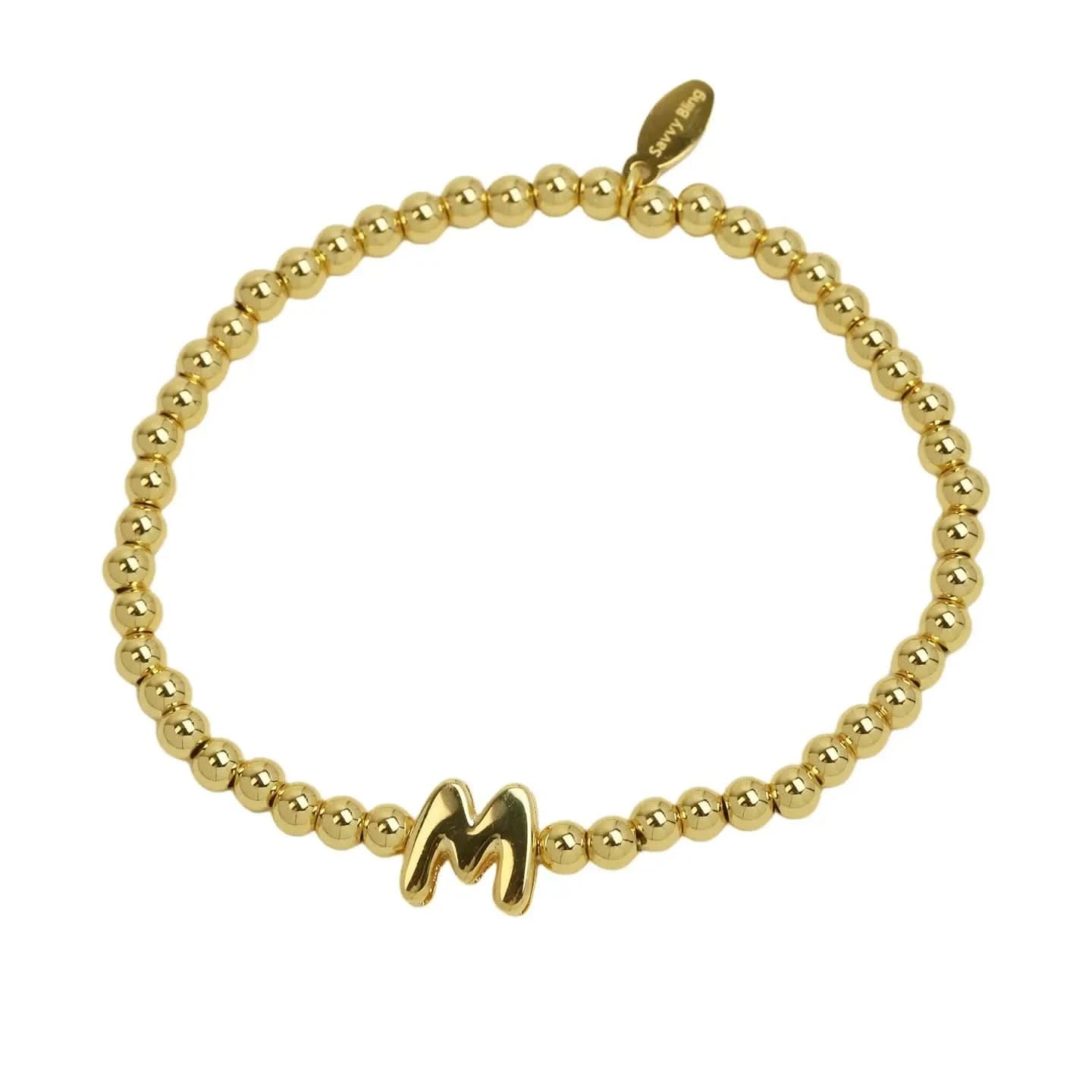 Gold beaded bracelet with a letter 'M' charm on a white background