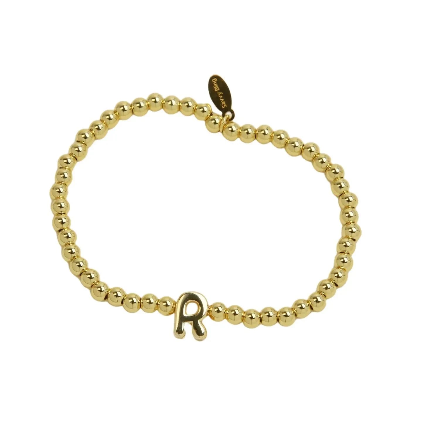 Gold beaded bracelet with a letter 'R' charm on a white background