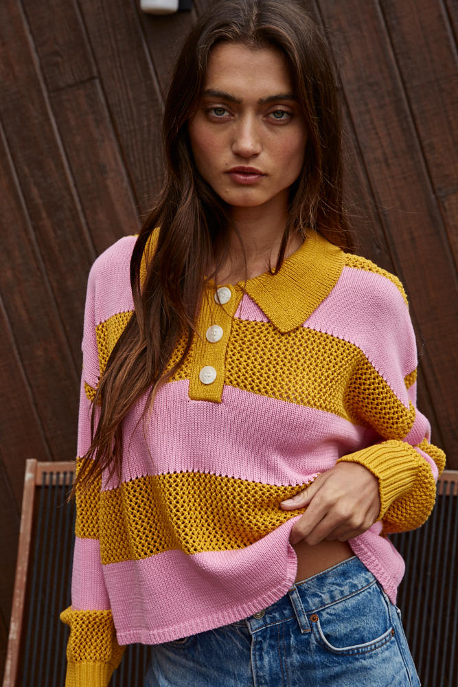 Woman wearing a pink and yellow striped sweater 