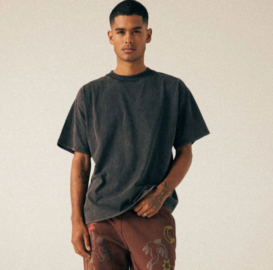 Man wearing black, vintage, washed, oversized, box, tee t-shirts with embroidered brown pants