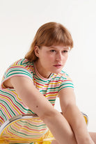 Woman wearing multi-stripe stripped t-shirt and yellow shorts 