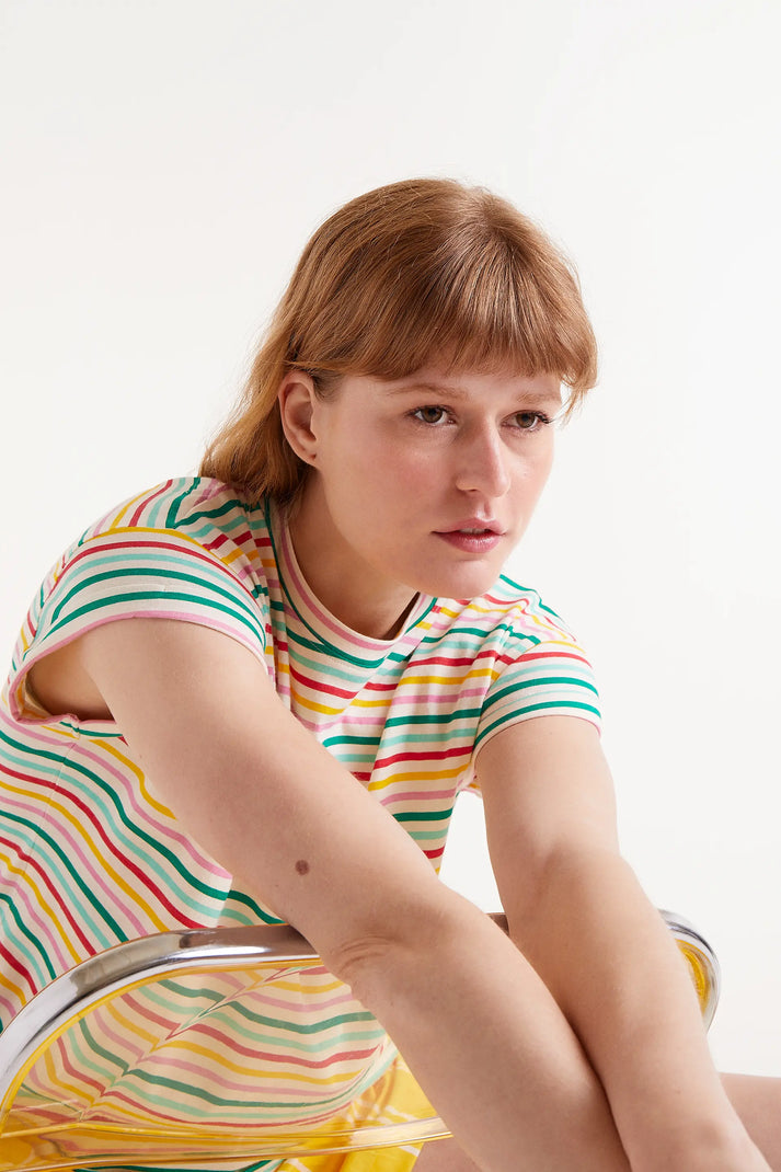 Woman wearing multi-stripe stripped t-shirt and yellow shorts 