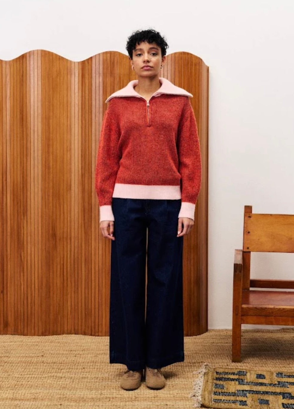 person wearing a red sweater with white collar 