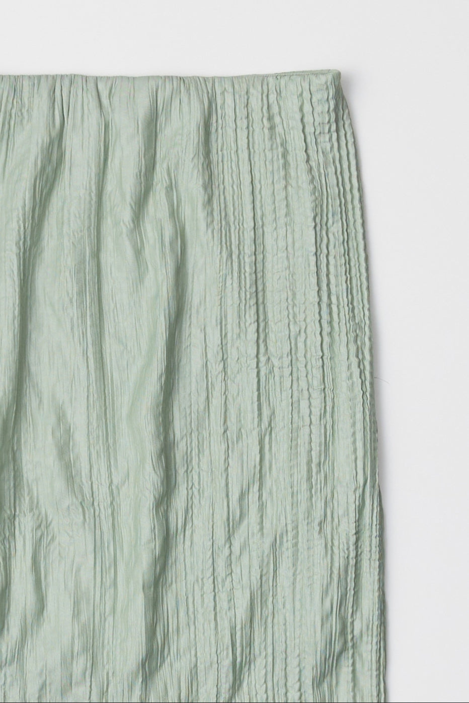 sea foam, Sage green textured skirt laid against a white surface 