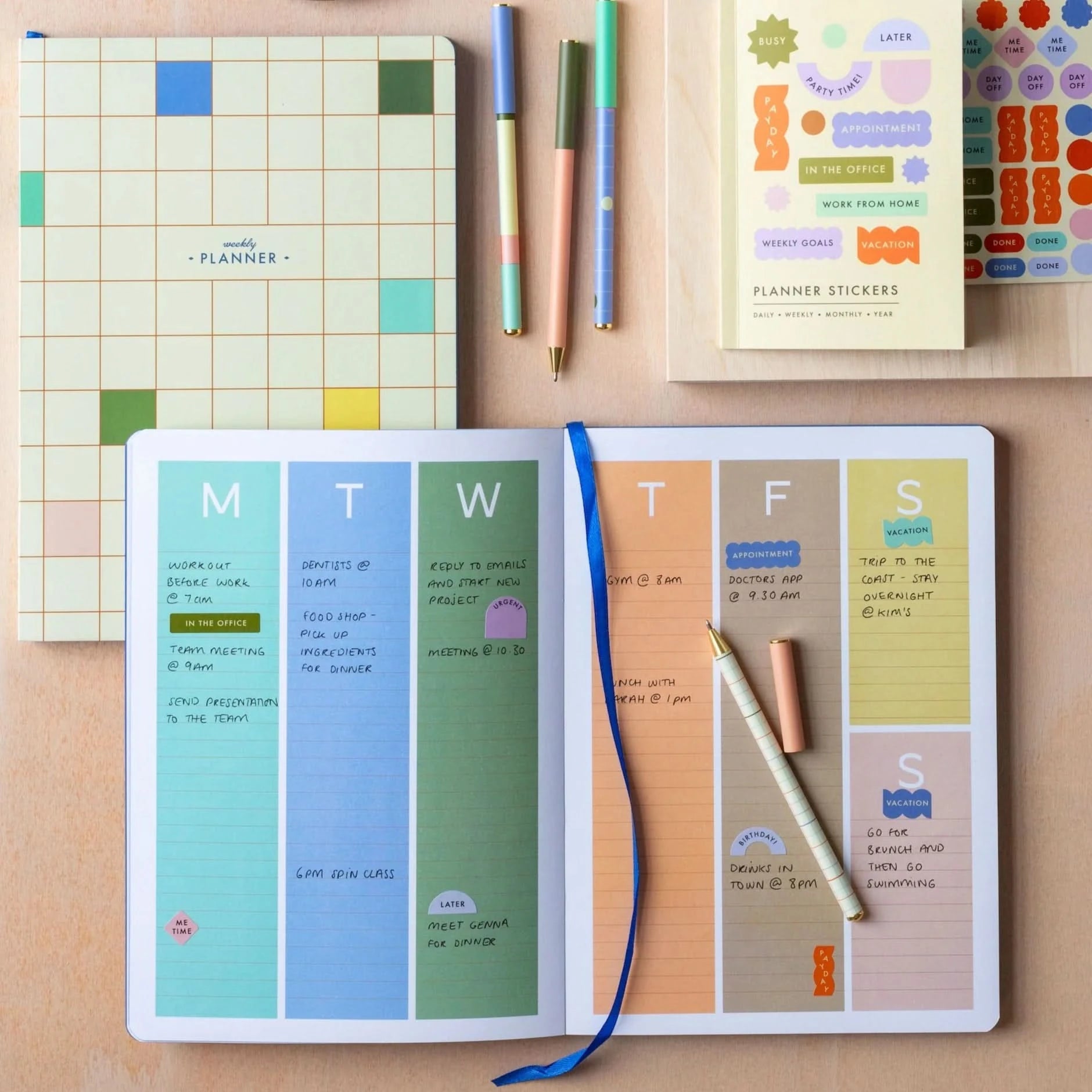 Open and in use colorful weekly planner Monday through Sunday 