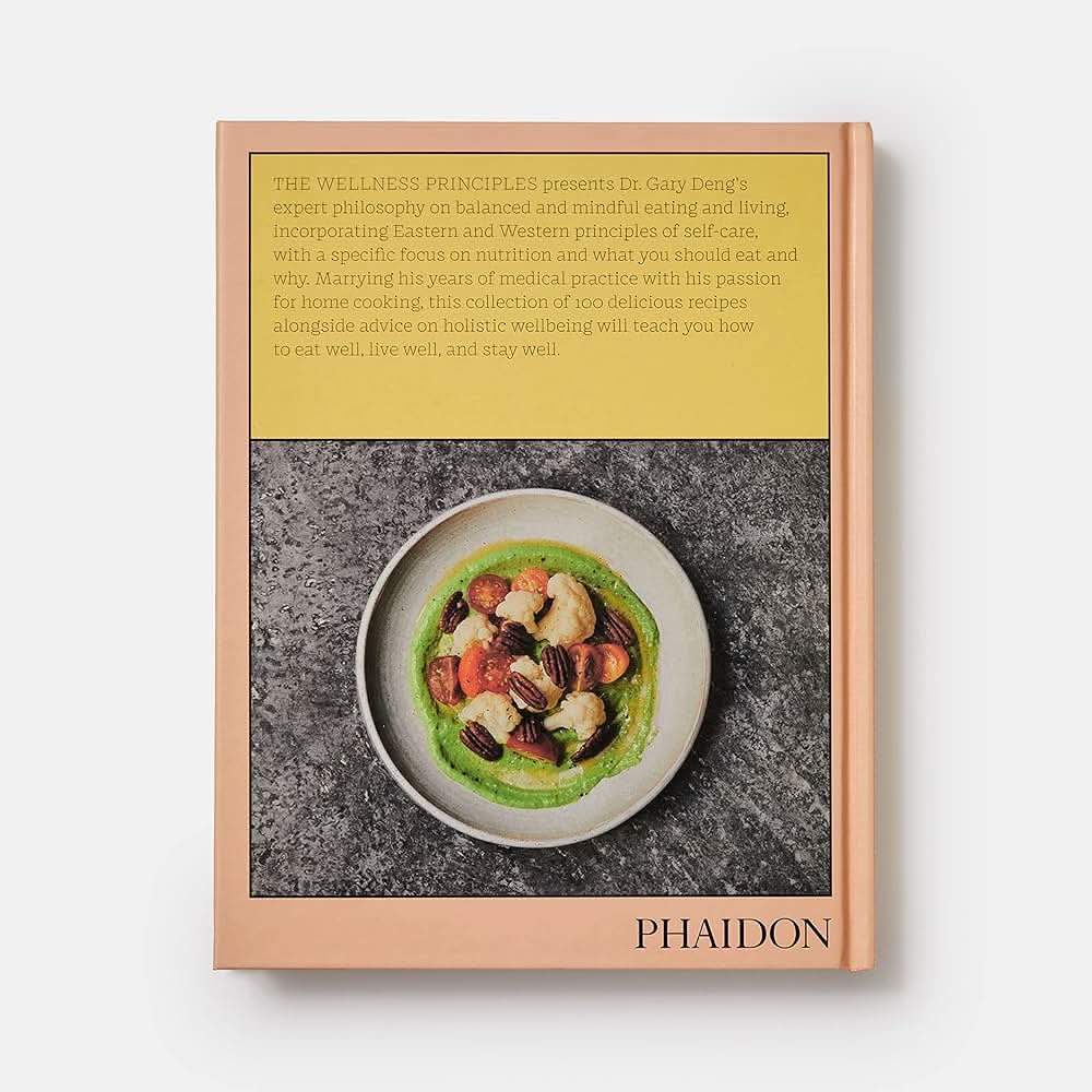 The back cover of the book “the wellness principles” with a picture of a beige bowl with split pea mash, cauliflower, pecans, and tomatoes