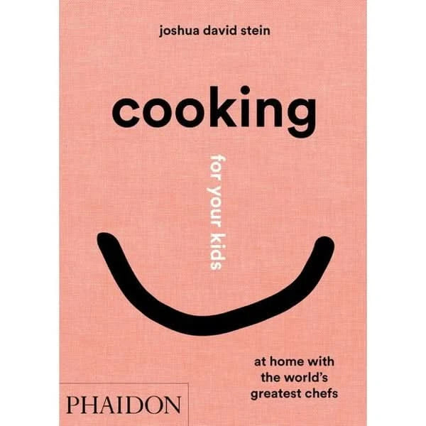Cover of “Cooking for your kids” pink aesthetic cookbook by Joshua David stein picturing an abstract smile