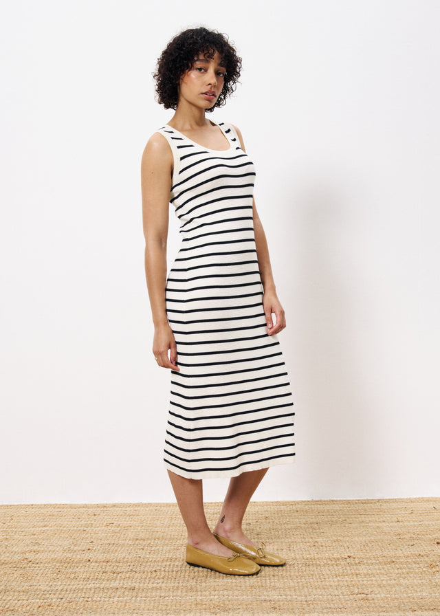 Woman wearing sleeveless long knit dress black and white stripe 