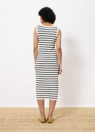 Woman wearing sleeveless long knit dress black and white stripe 