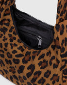 Small leopard purse with a black inside zipper behind a white background. 