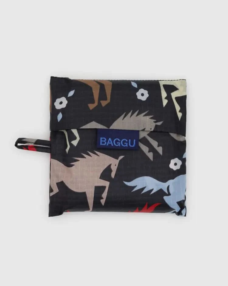 Folded up Dark grey black baby baggu reuseable bag with colorful horse cutouts throughout the print 