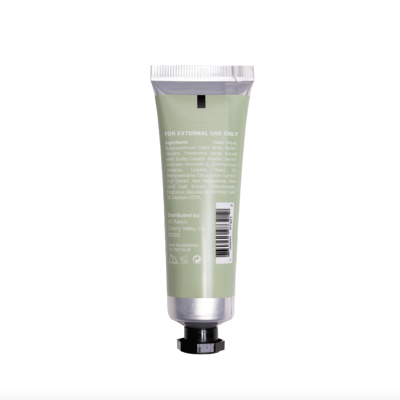 Green hand cream tube with silver cap on a white background