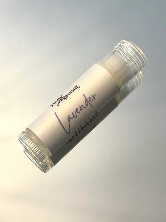 Lip balm stick labeled 'Lavender' on a gradient gray background