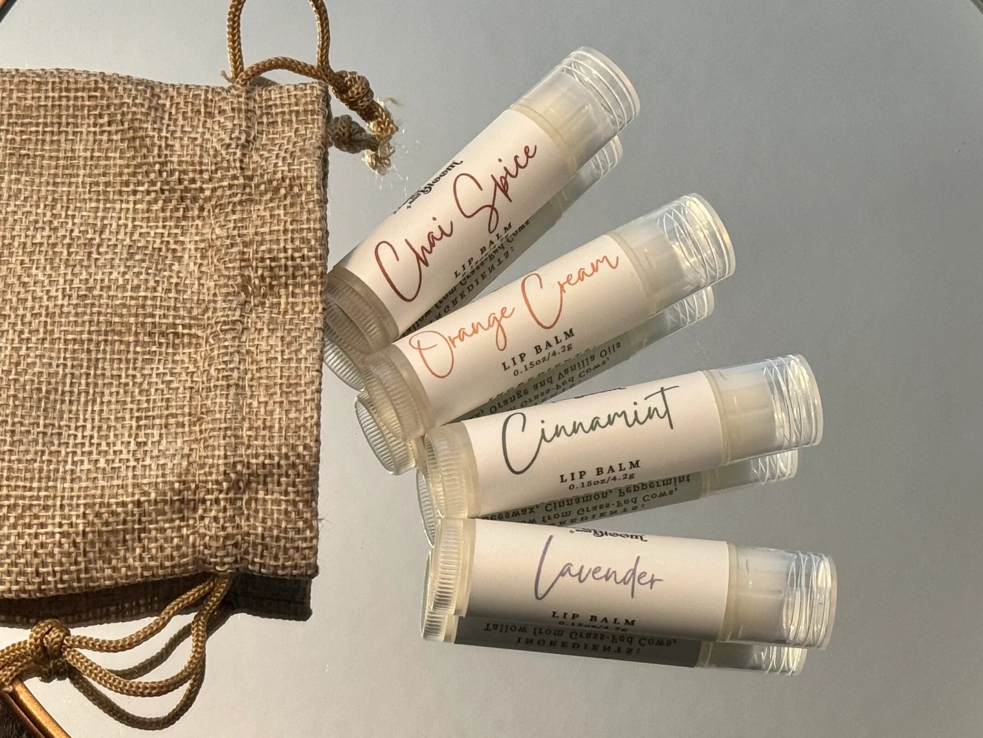 Set of lip balms with visible labels on a gray background