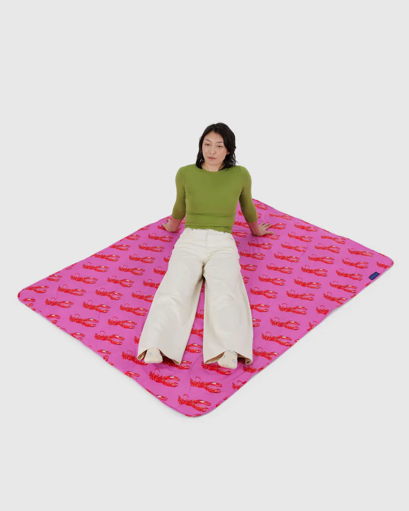 Person sitting on a pink mat with red car pattern