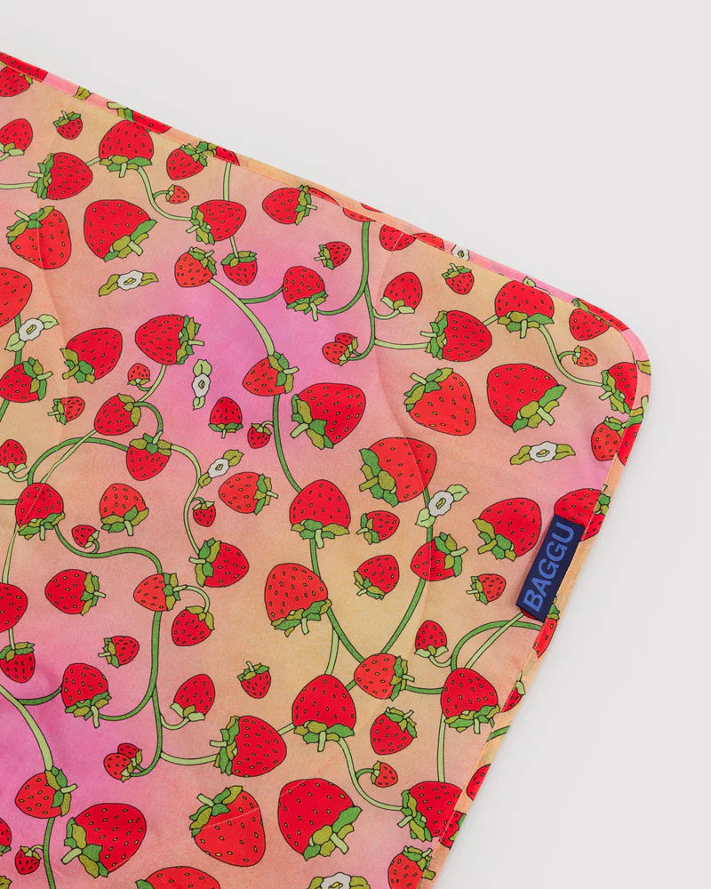 Reusable bag with strawberry pattern on a light pink background
