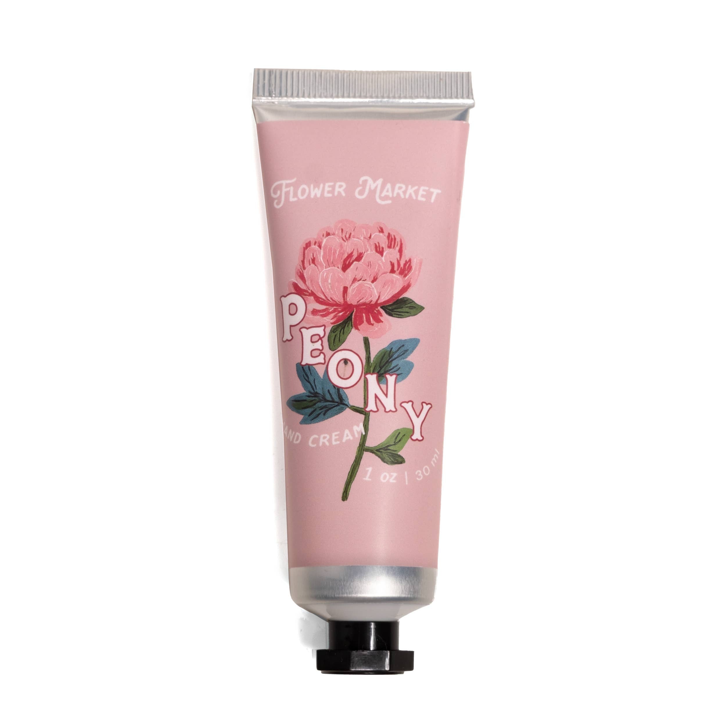 Hand cream tube with pink packaging and floral design on a white background
