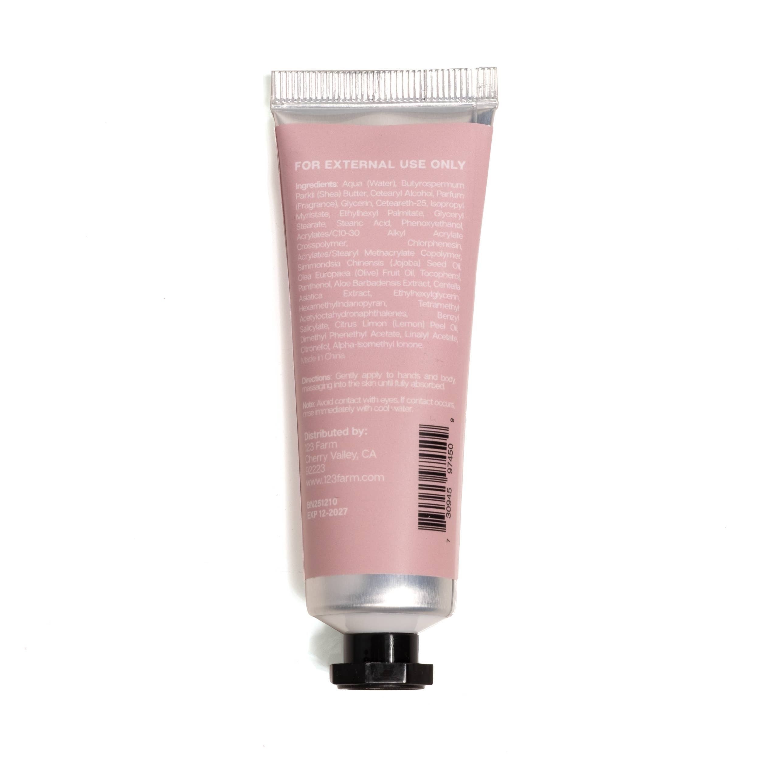 Pink tube of cream with silver cap on a white background