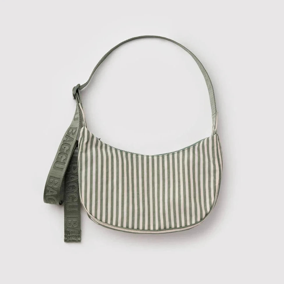 Green and white striped handbag with a strap on a light gray background