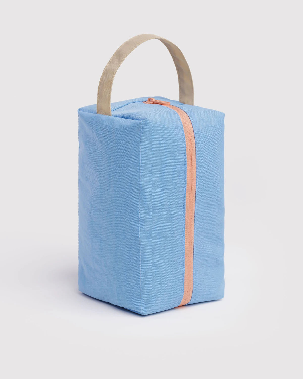 Blue rectangular bag with a handle on a light gray background