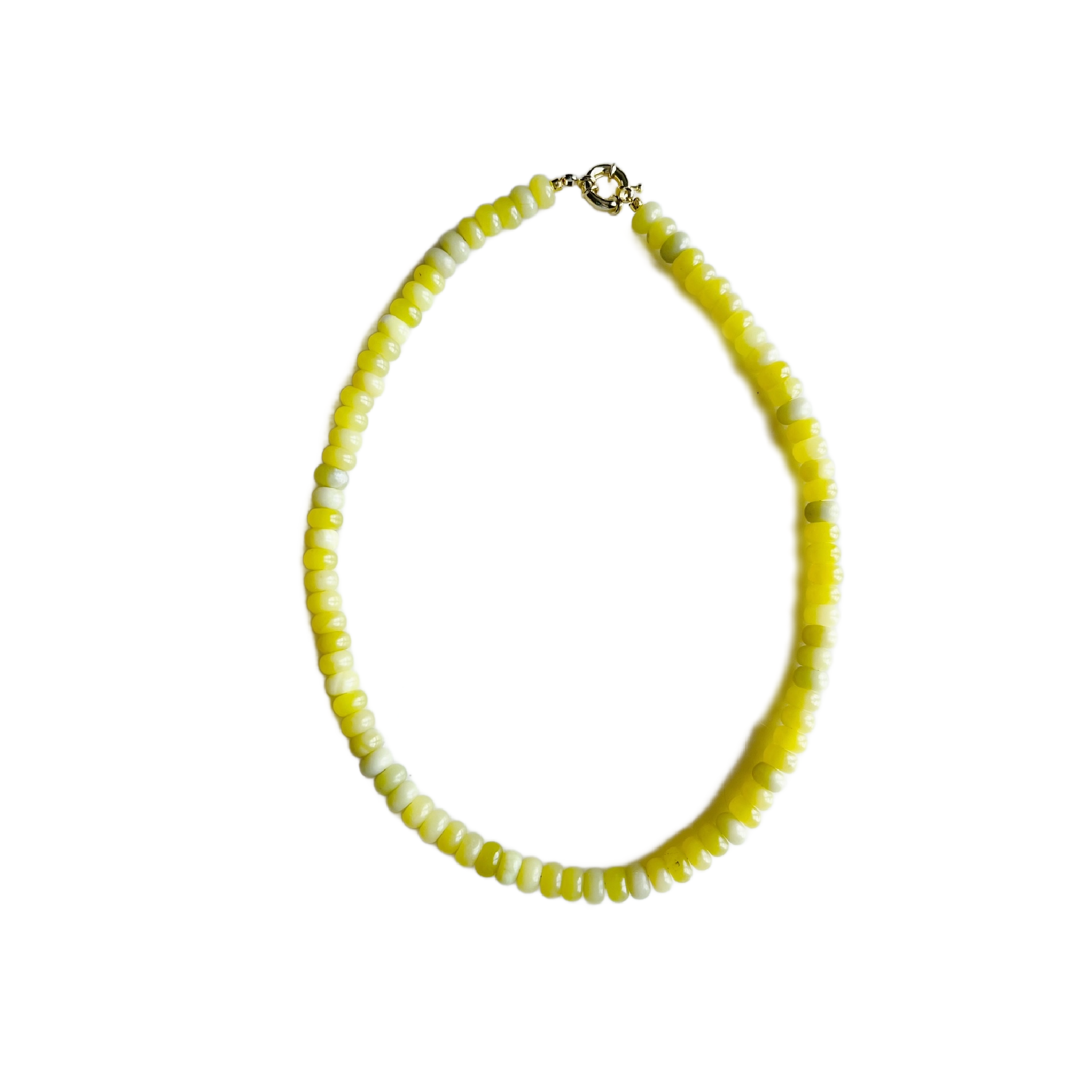 Necklace with yellow and white beads on a white background