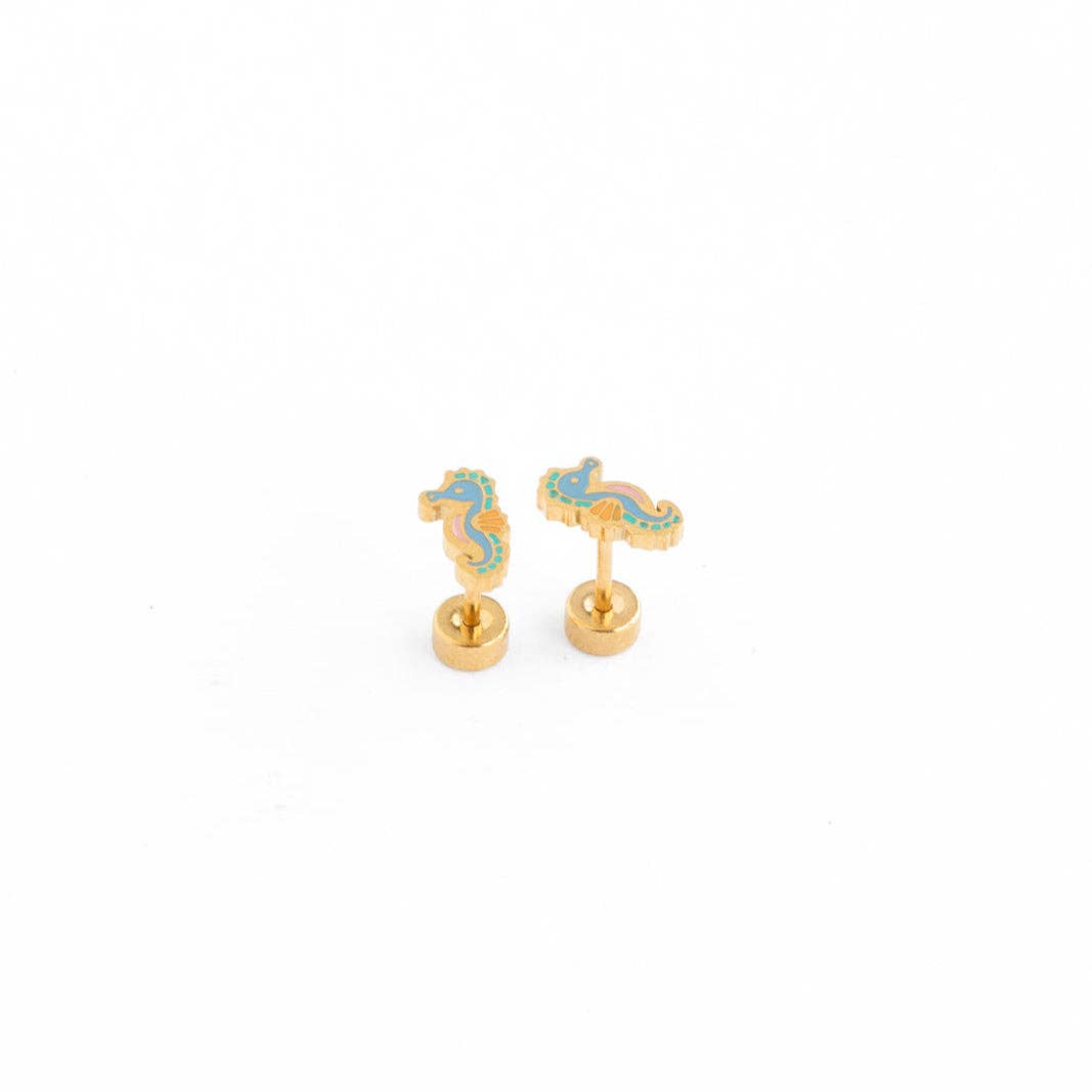 Gold and blue seahorse-shaped earrings on a white background