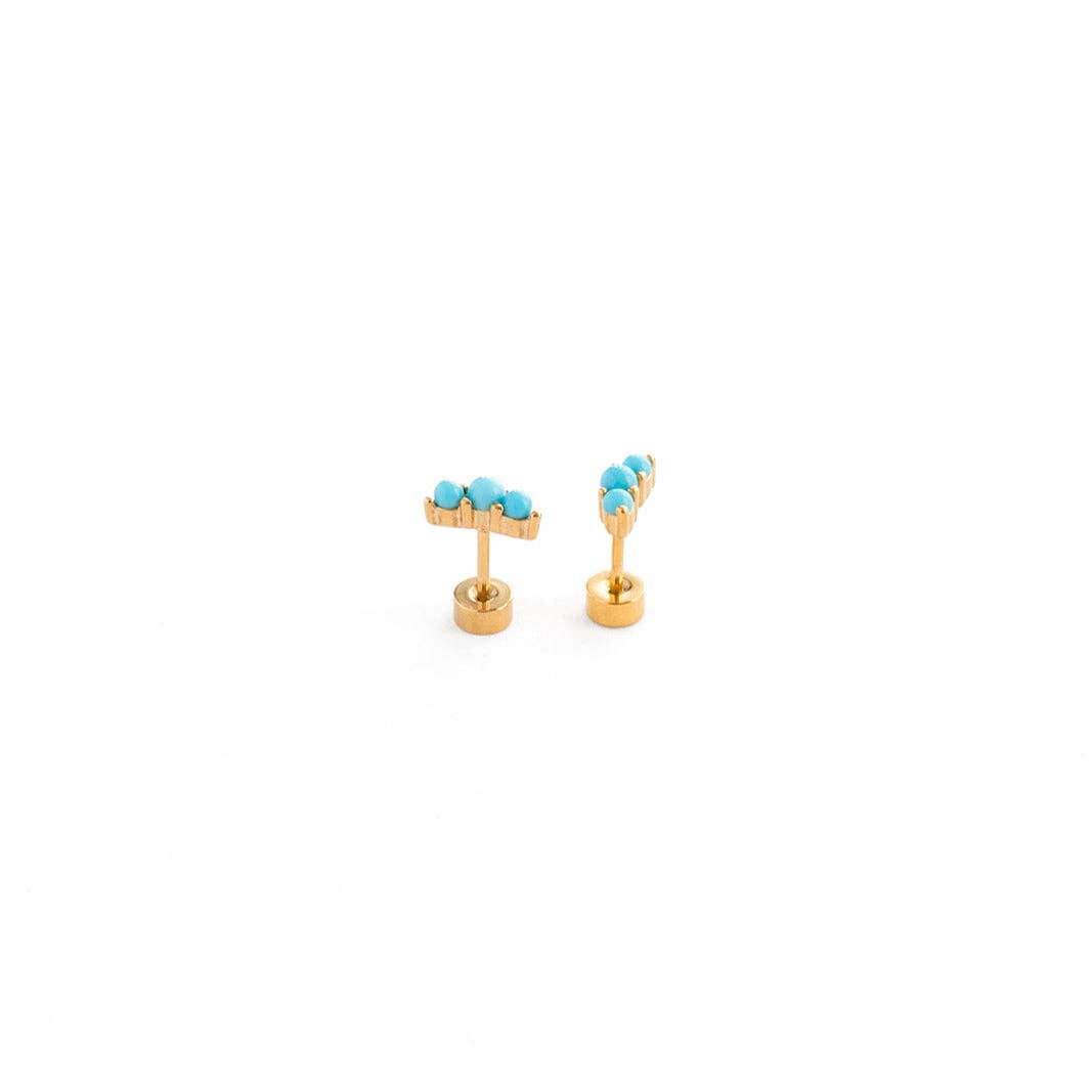 Gold earrings with turquoise stones on a white background
