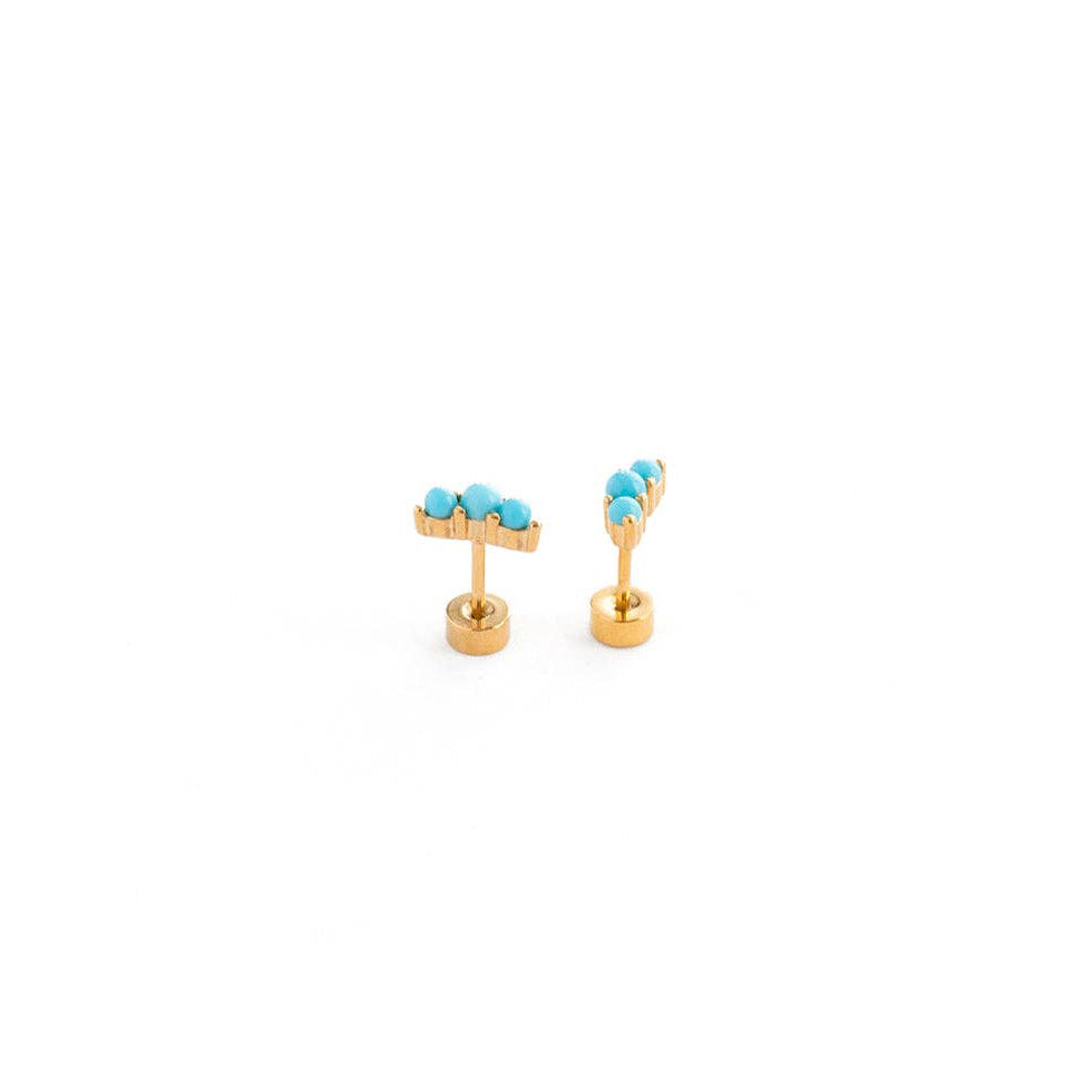 Gold earrings with turquoise stones on a white background