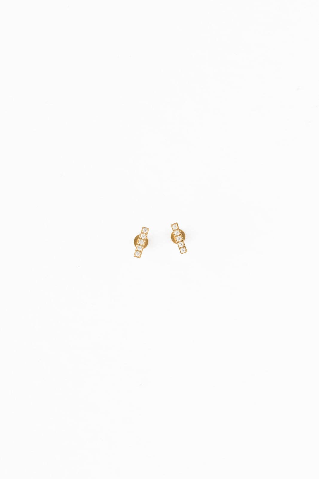 Gold earrings on a white background