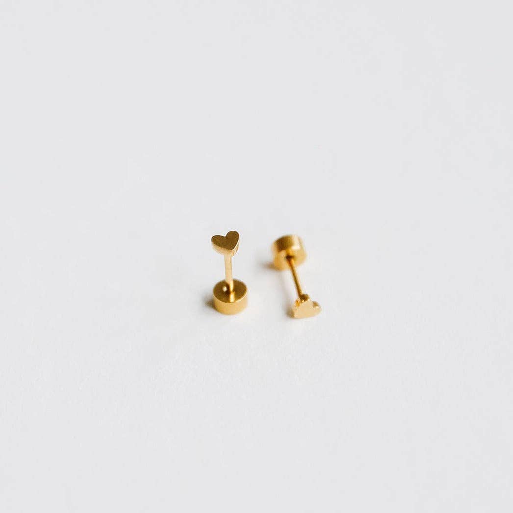 Pair of gold heart-shaped earrings on a light gray background