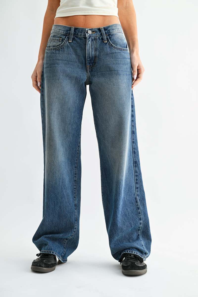 Person wearing blue jeans on a white background