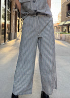 model wearing denim and cream striped vintage style pants 