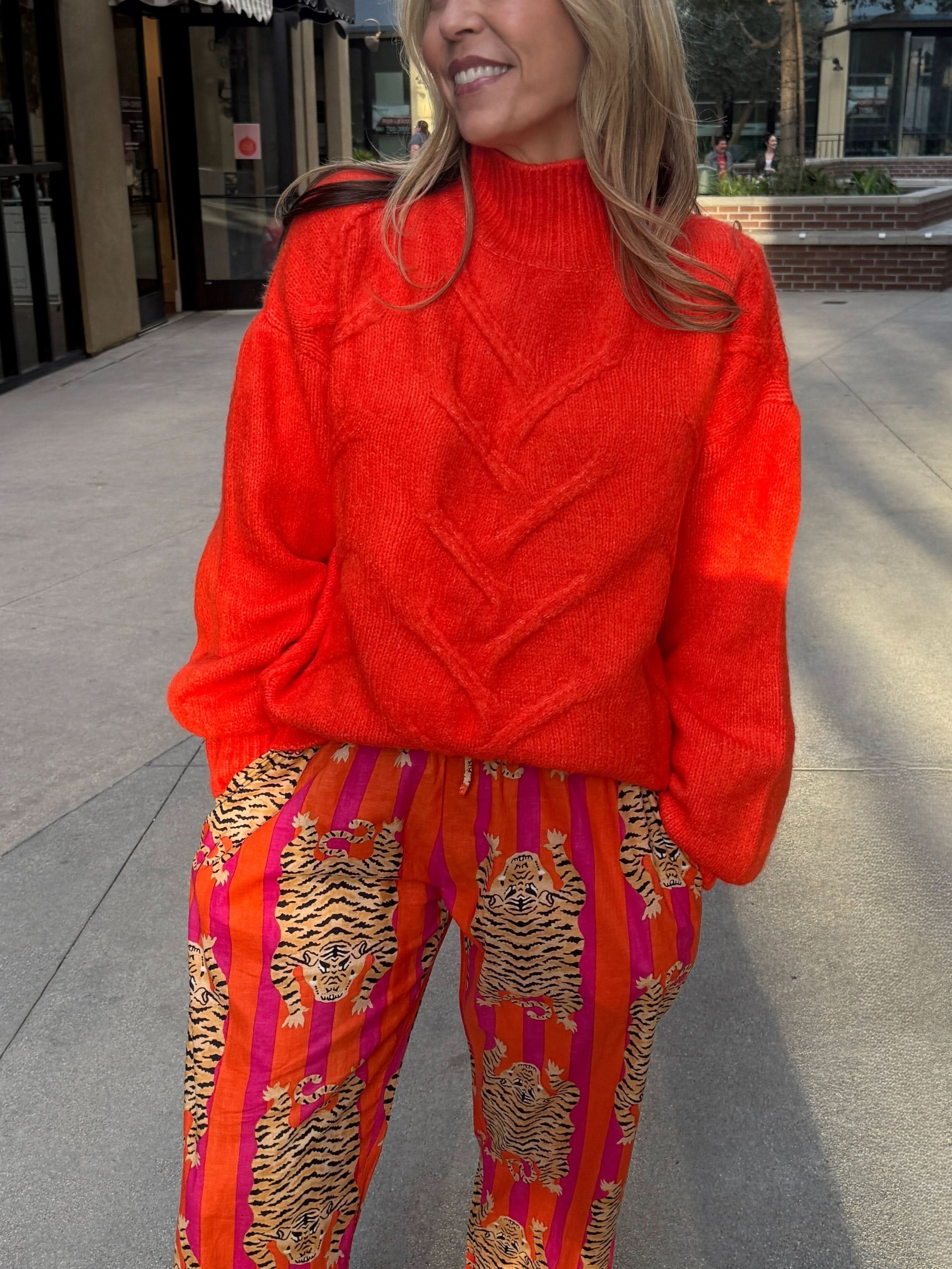 woman wearing Bright Orange fisherman knit sweater