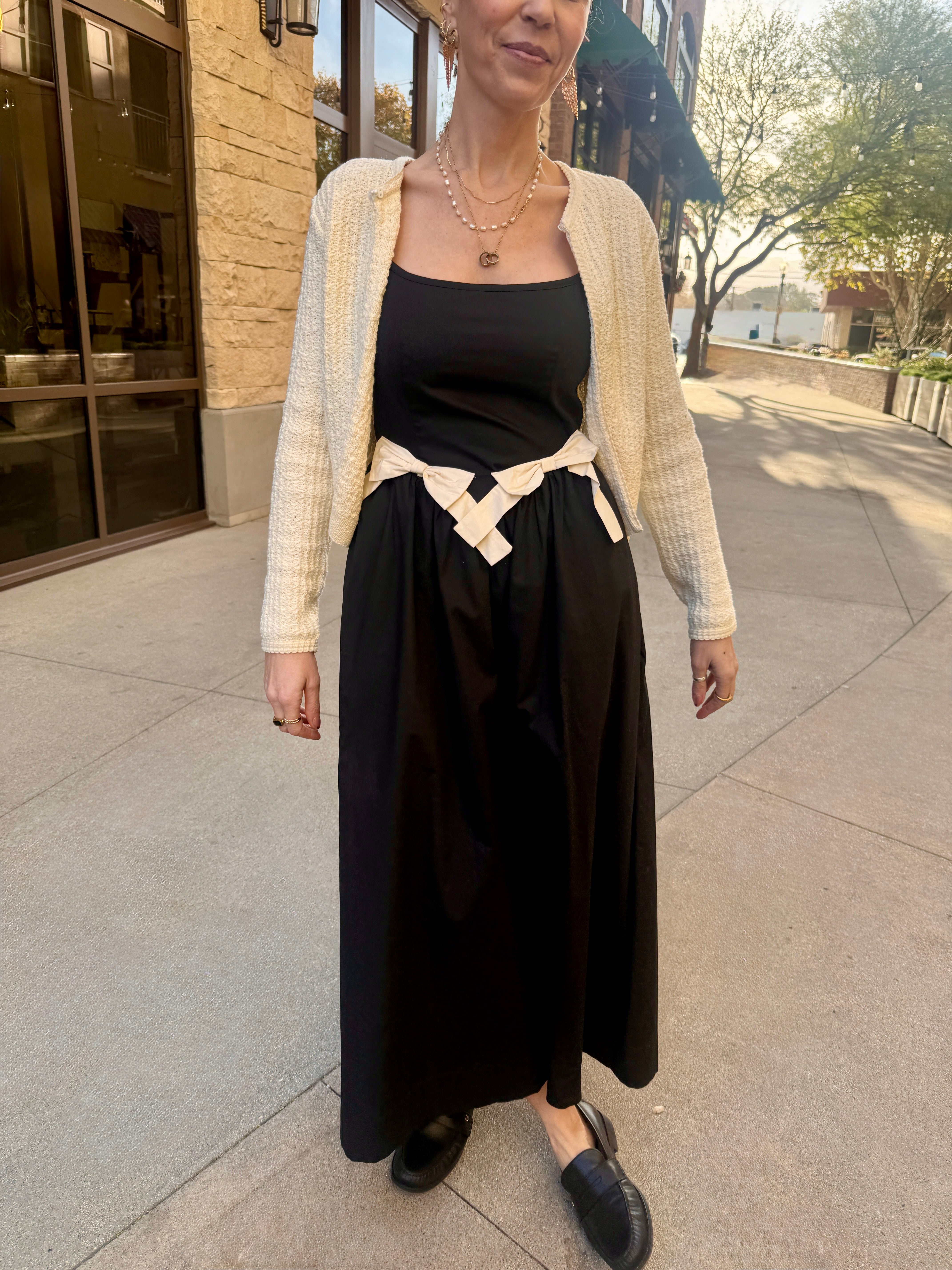 moon river black midi dress with two white bows with white cardigan 