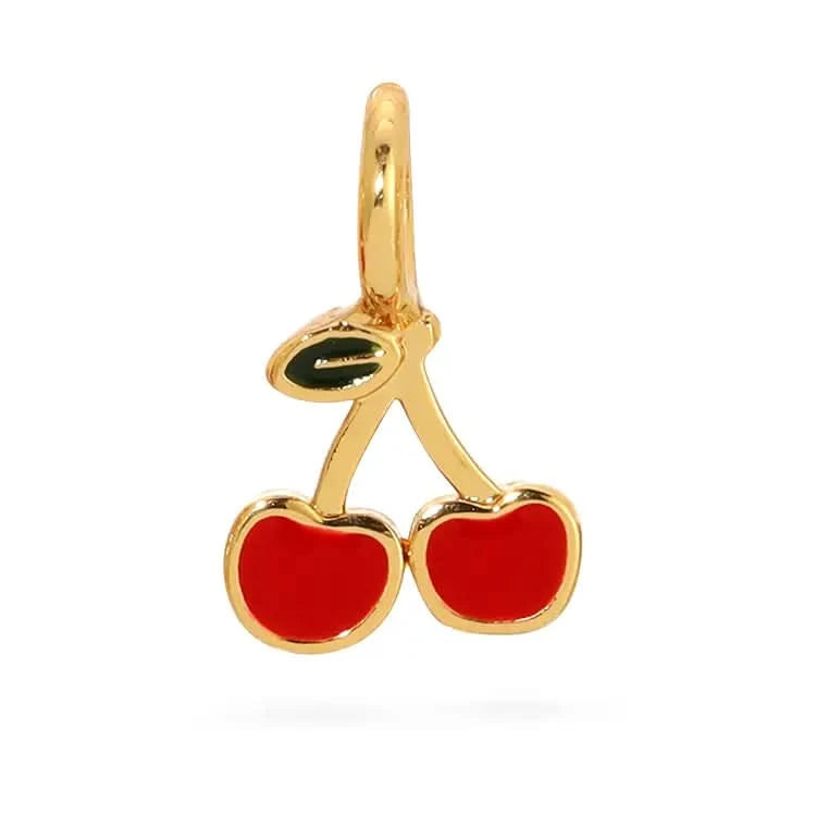 Gold cherry-shaped pendant with red stones on a white background