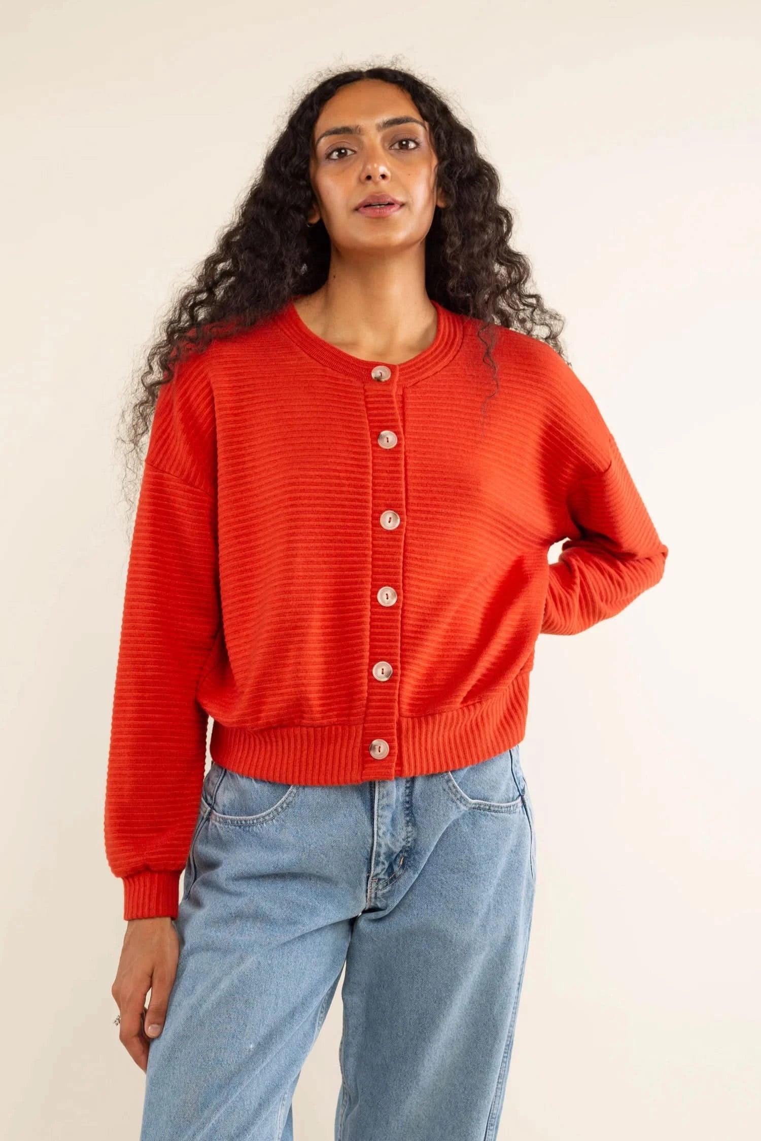 model wearing oversized orange button up cardigan sweater 