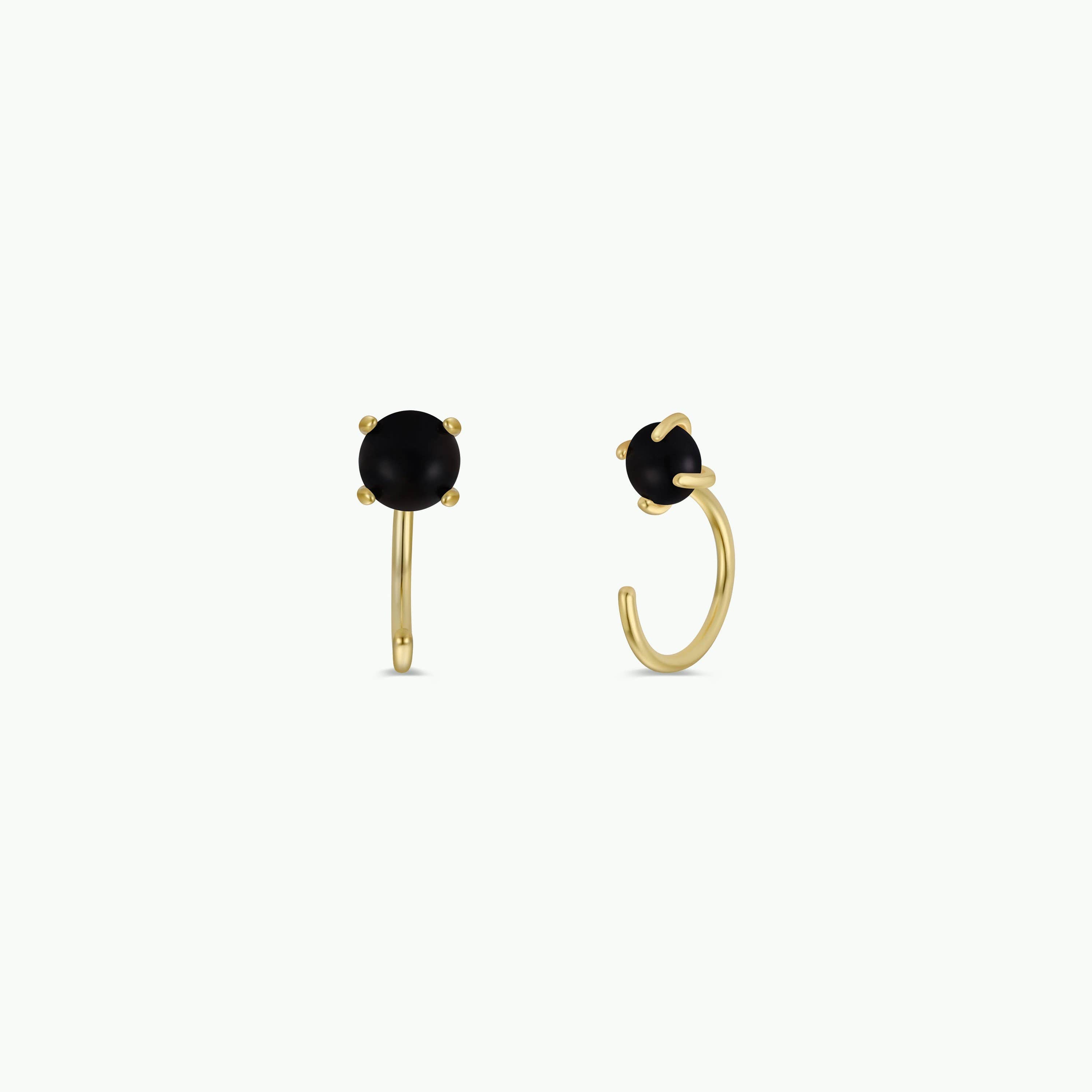 Gold hoop earrings with black gemstones on a white background
