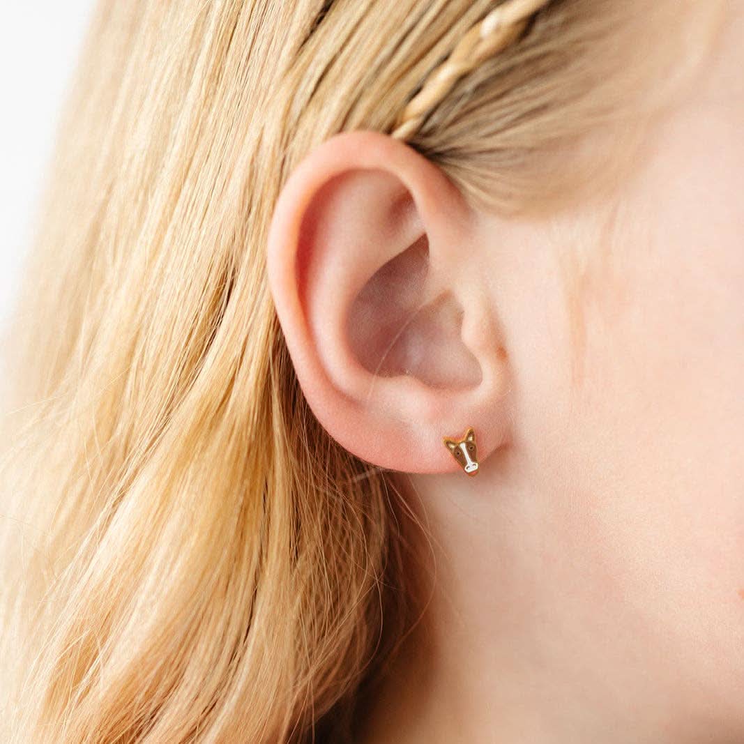 Child wearing A pair of Brown and white horse flat-back gold earrings