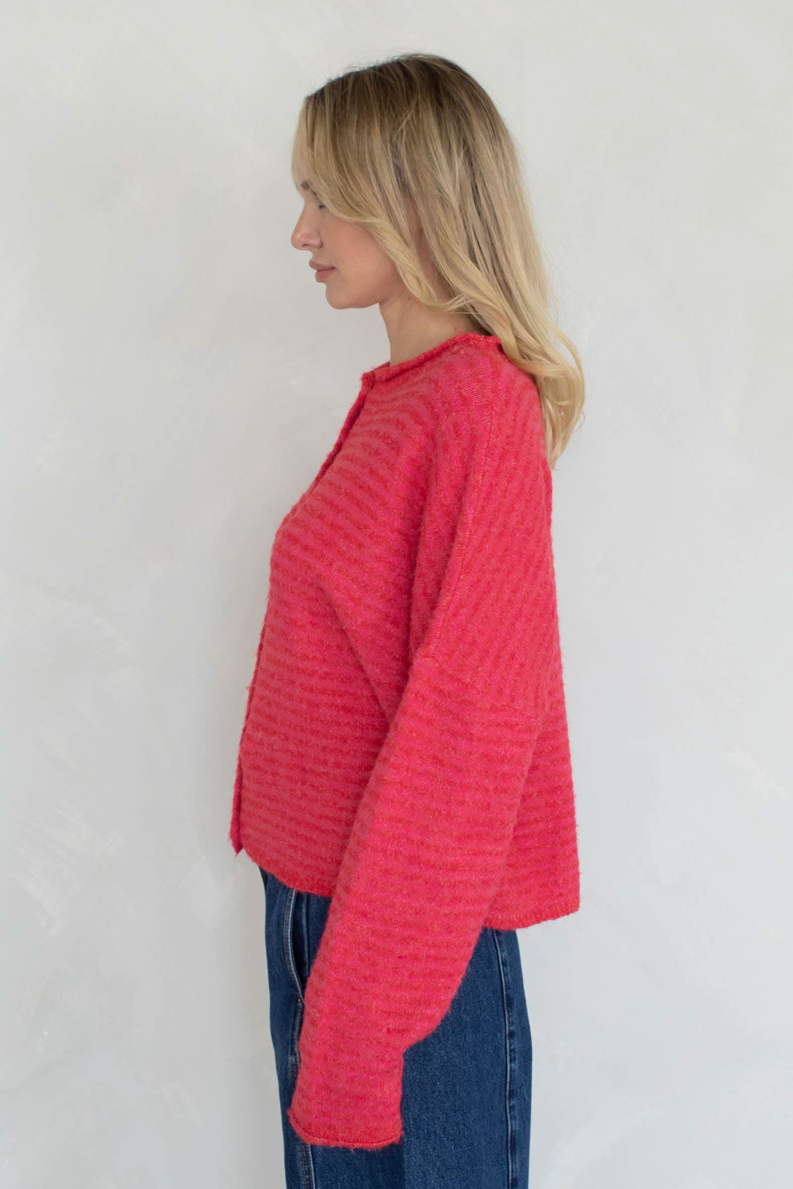 Woman wearing a red knitted Soft and cozy cardigan in mini stripes