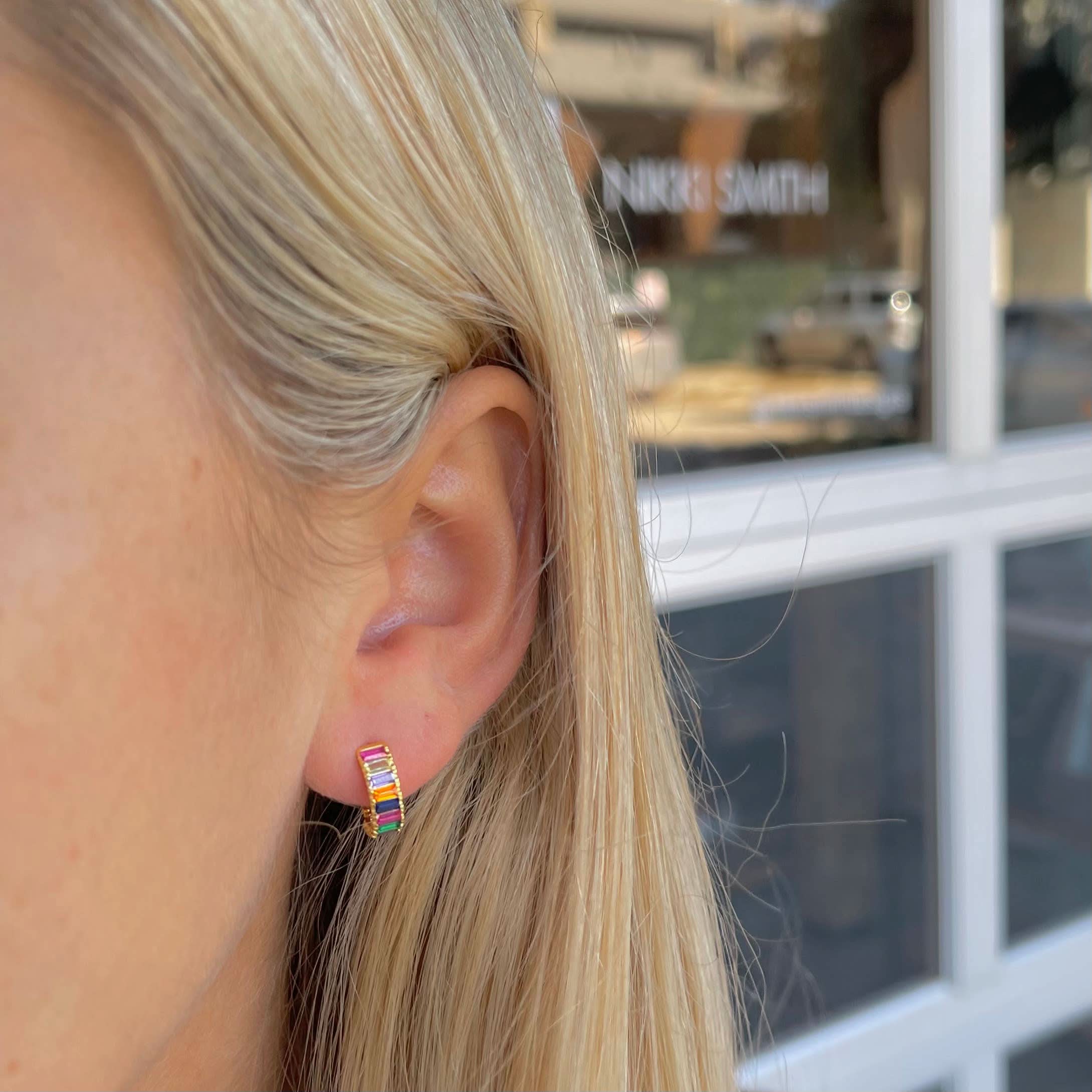 Woman wearing Small sized rainbow gem huggie earrings
