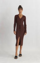 woman wearing brown midi length silhouette dress with v-neckline, collar, button-front detail and waist belt for  shape