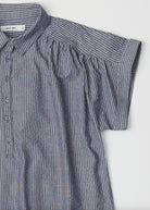 close up striped white and blue jean gray half button top with collar and cuffed sleeves 