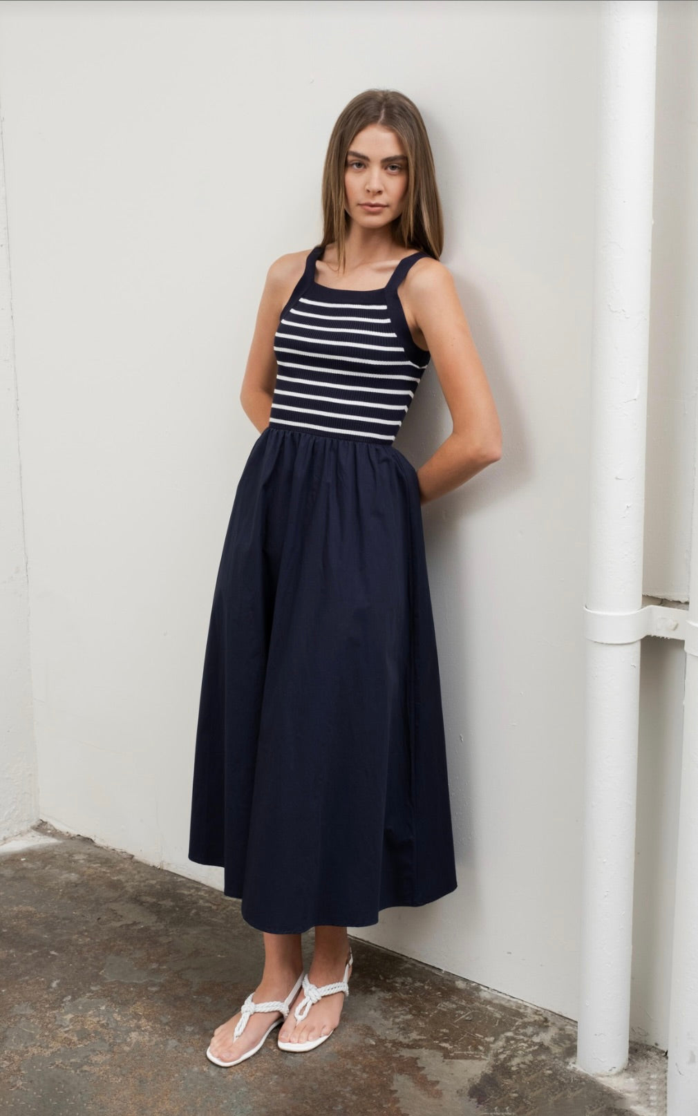 Woman wearing square neck striped sweater top dress in black and white 