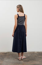 Woman wearing square neck striped sweater top dress in black and white 