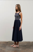 Woman wearing square neck striped sweater top dress in black and white 