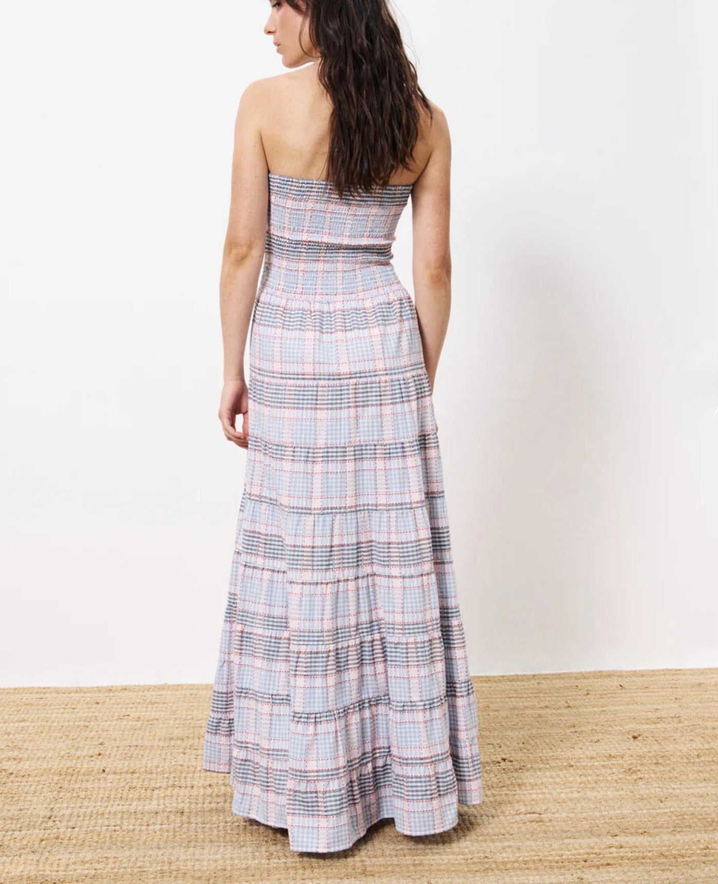 Woman wearing long red white and blue striped strapless dress, smocked on the chest