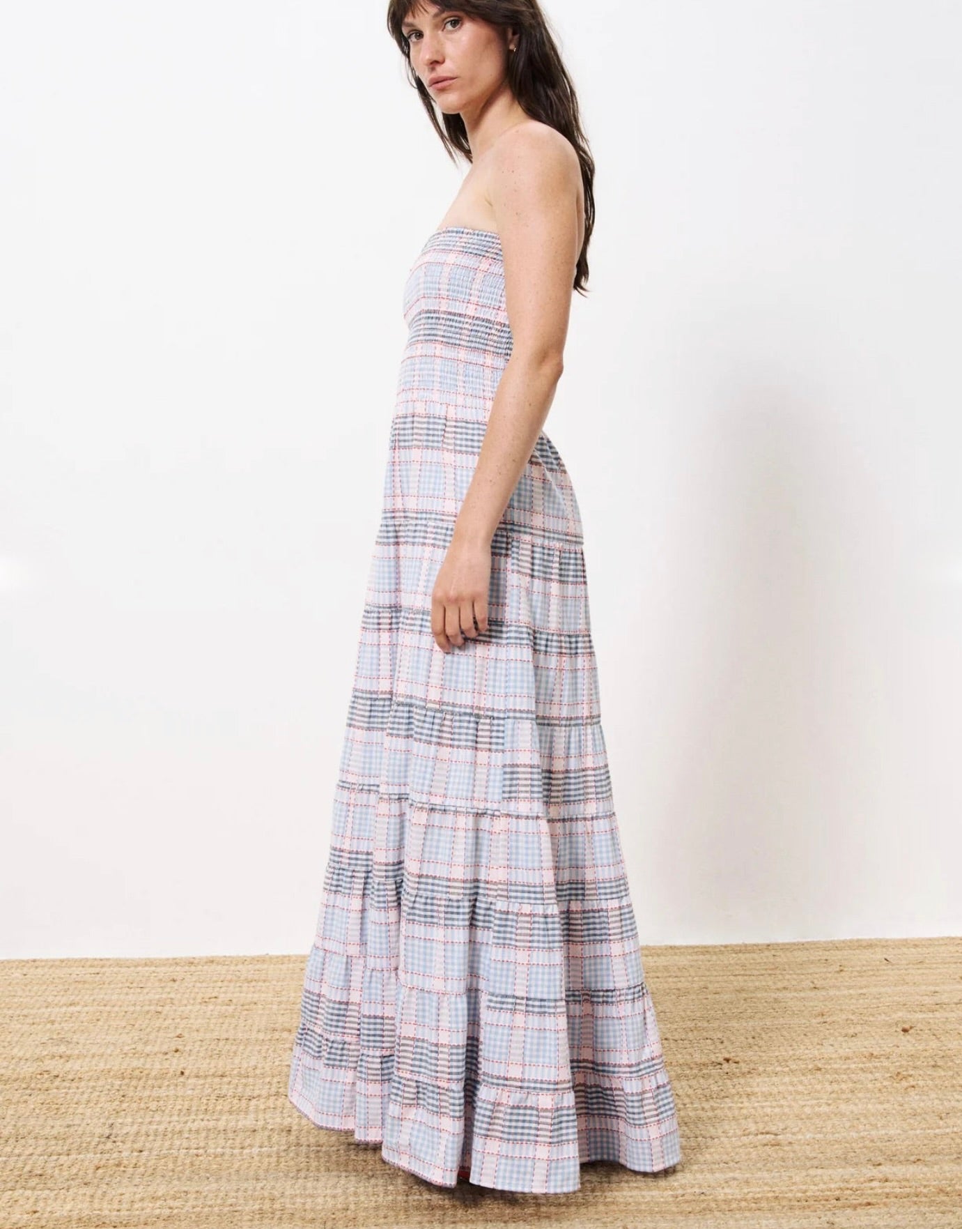 Woman wearing long red white and blue striped strapless dress, smocked on the chest